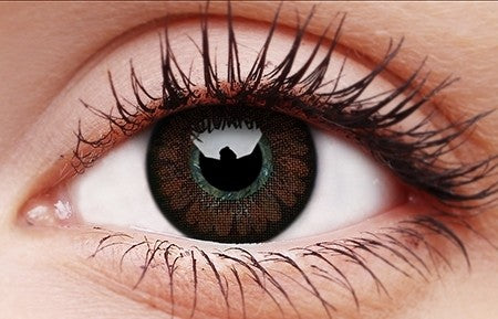 Close-up of an eye wearing green-brown colored contact lens with natural pattern and defined pupil opening